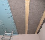 Sheep Wool Insulation Premium Roll being installed at ceiling level from the underside. The insulation is held with staples prior to fitting an airtight membrane.